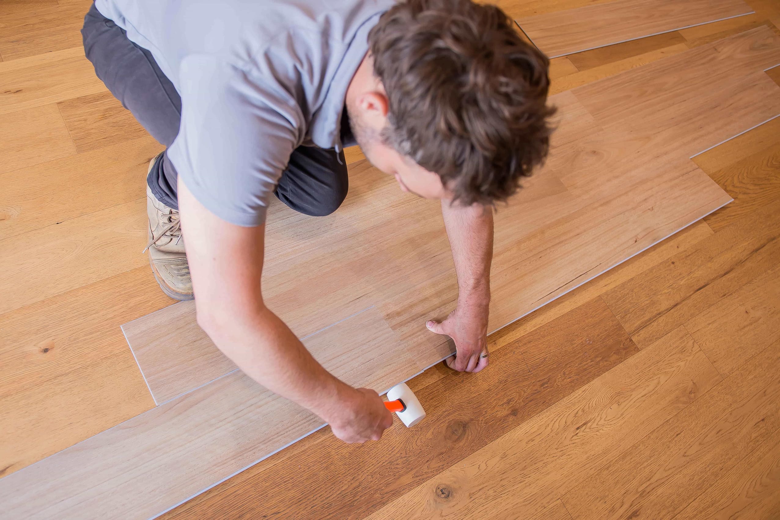 Installer fixing hybrid flooring planks